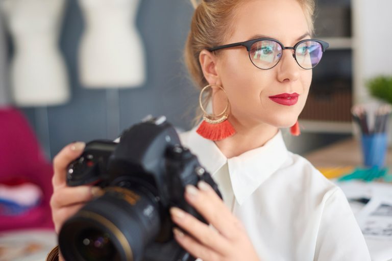 Thoughtful young woman holding camera Mélységélesség - Milyen beállítást használjak? - NEXTFOTO
